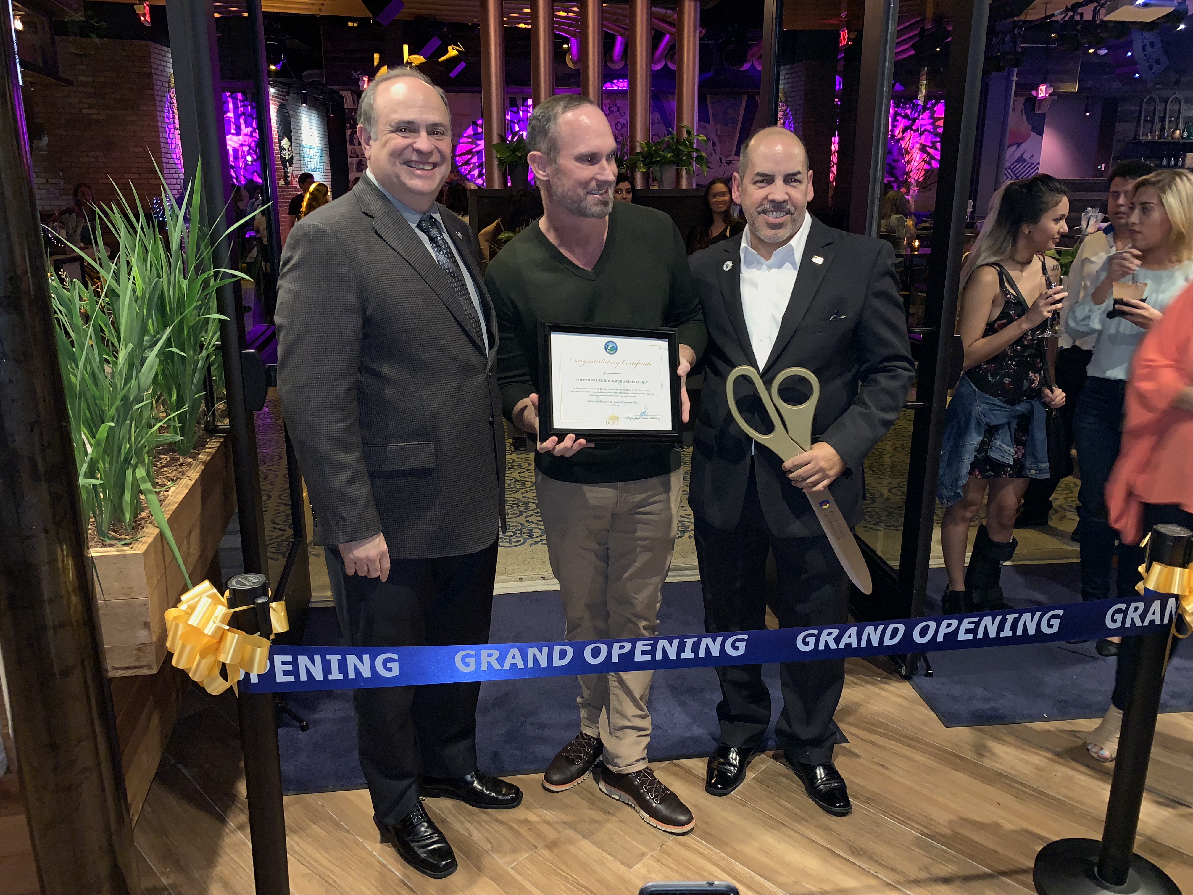 Ribbon cutting in Copper Blues Improv hosted by the Doral Chamber of Commerce.