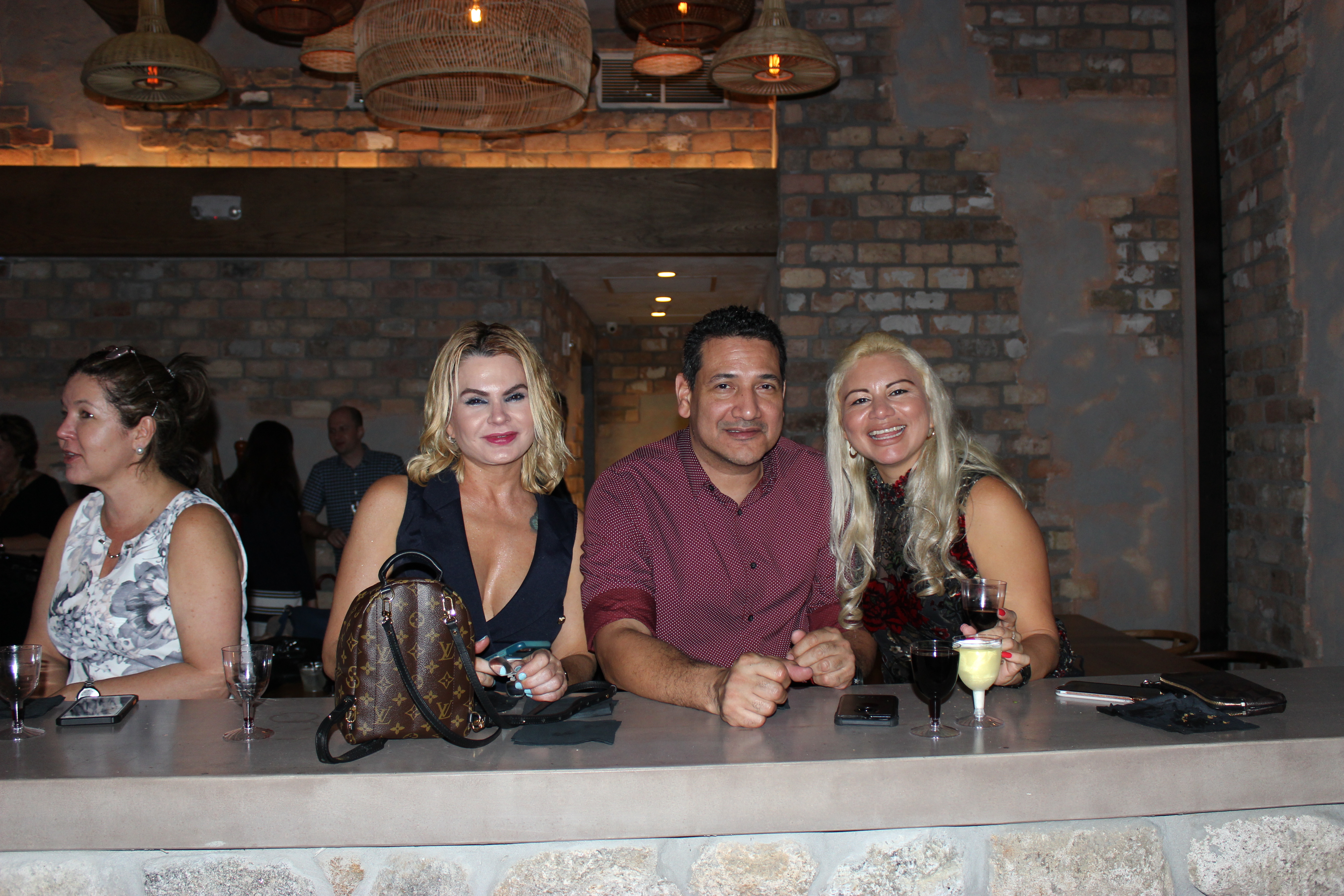 Doral Chamber of Commerce introduces Novecento Grand Opening Event, group photo with 2 ladies.