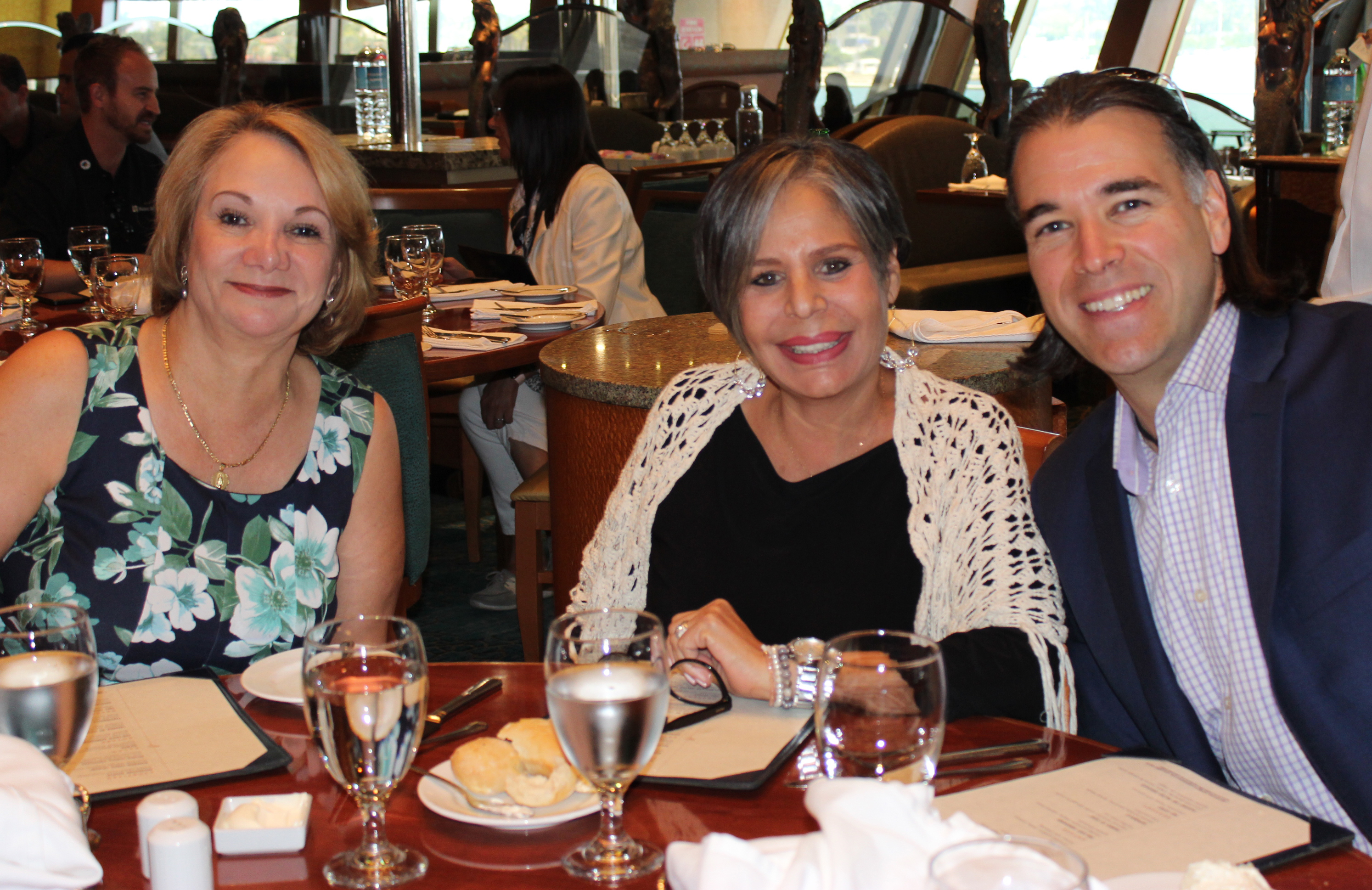 Doral Chamber of Commerce Carnival Cruise Luncheon 2019, Networking Event in Miami, Florida. Group photo at a table in Carnival Cruise dining hall.