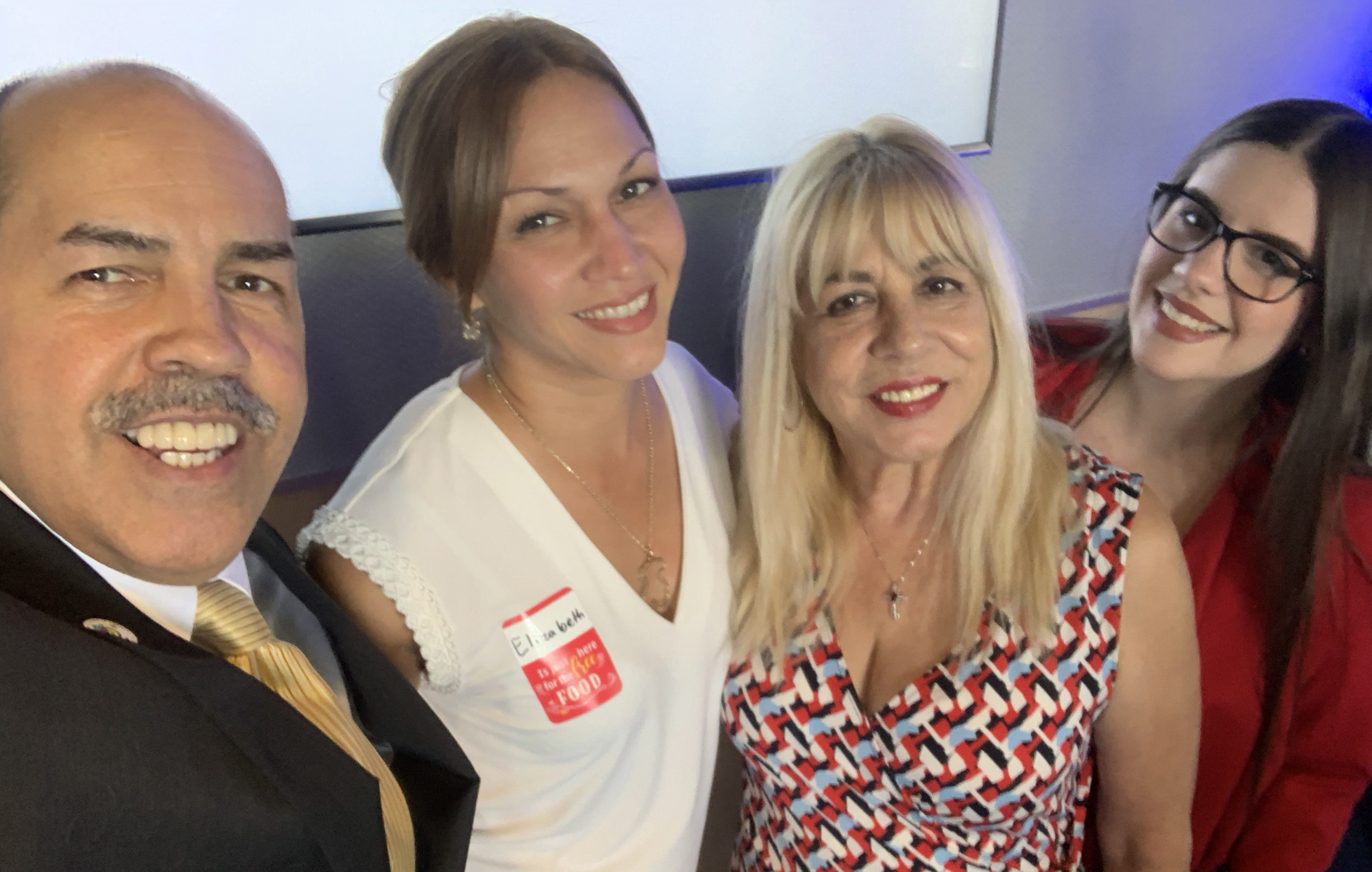 Doral Chamber of Commerce introduces Manny Sarmiento and Carmen Lopez taking a selfie with members at TopGolf Doral Networking Luncheon.