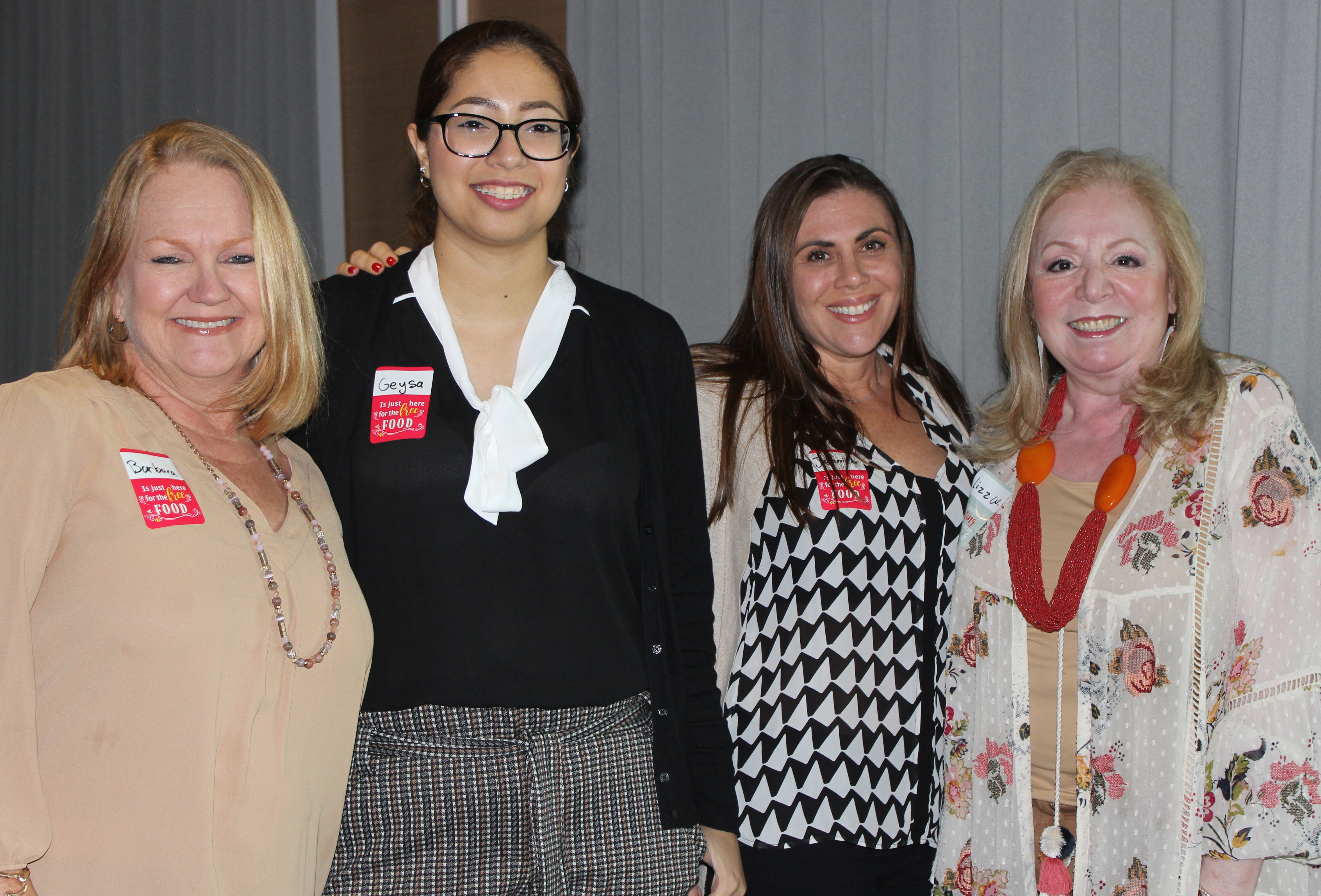Doral Chamber of Commerce introduces a group of female members taking a photo together at Topgolf Doral Networking Luncheon Event.
