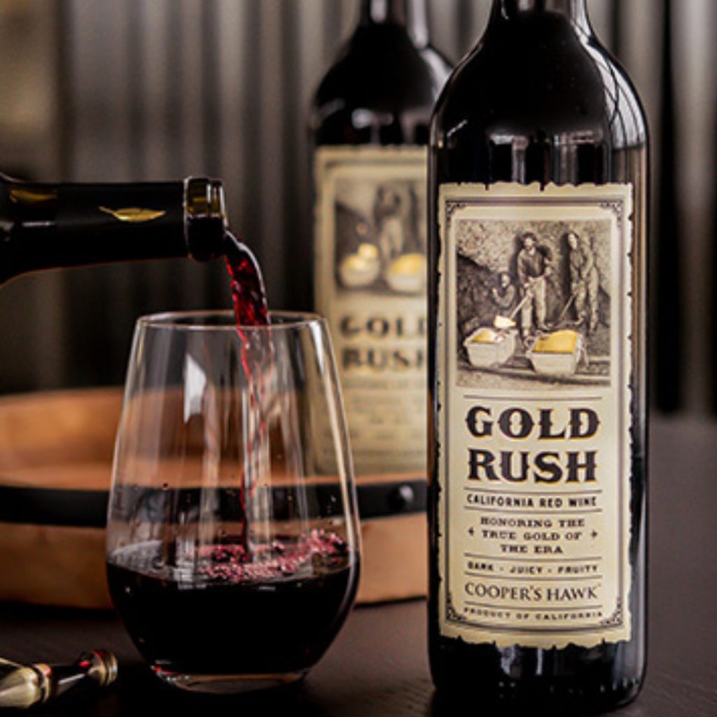 Cooper's Hawk Winery & Restaurant Join the 1 bottle per month Club for $21.99 by April 24 to take home a bottle of the Gold Rush. Enjoy your bottle of Gold Rush in our dining room, or take them home to e enjoy Gold Rush is an inky, opulent blend with robust flavors of blueberry jam, black cherry, and black plum. Aromatic, spicy notes of violet and pepper are matched with a long finish of sweet baking spices. This is the ideal wine for a smokey, grilled steak or burger! The label reflects the history of California’s Gold Rush.